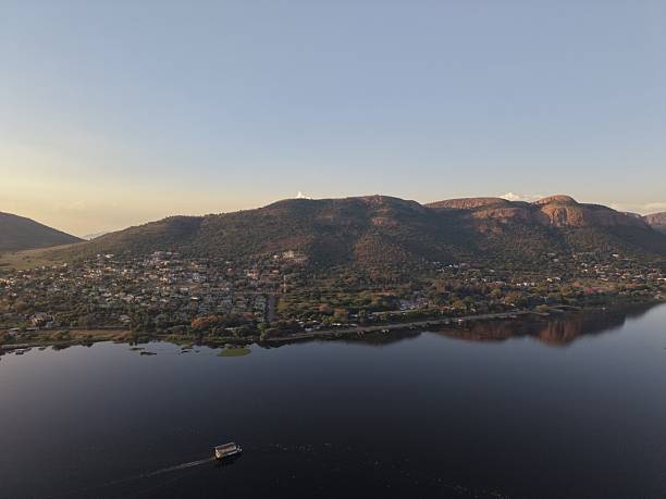 This breathtaking aerial shot captures the serene beauty of Hartbeespoort, South Africa, as the sun sets over the landscape.