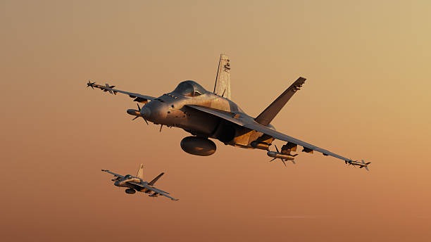 istock Two tactical twin jet engine fighter aircraft on a combat mission. Modern war jet airplanes flying in formation. Military planes silhuette against sunset. Sound barrier speed, air to air. 2256940170
