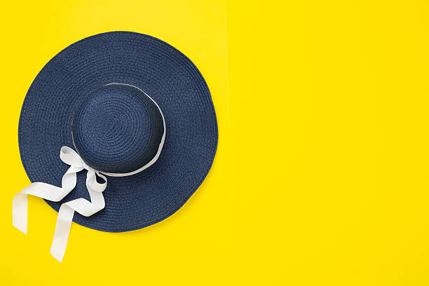 Blue beach hat on color background,top view