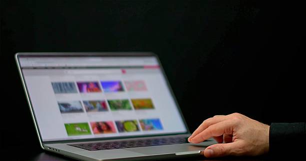 CloseUp Hand Browsing Laptop Screen Gallery, Evening Glow, Freelancer Selecting Image With Trackpad, Colorful