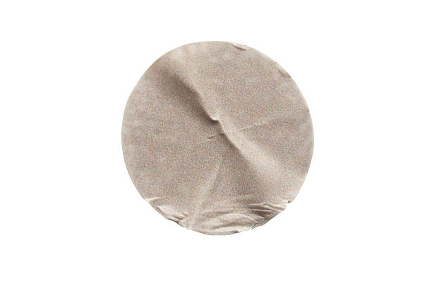 Blank brown round adhesive paper sticker label isolated on white background
