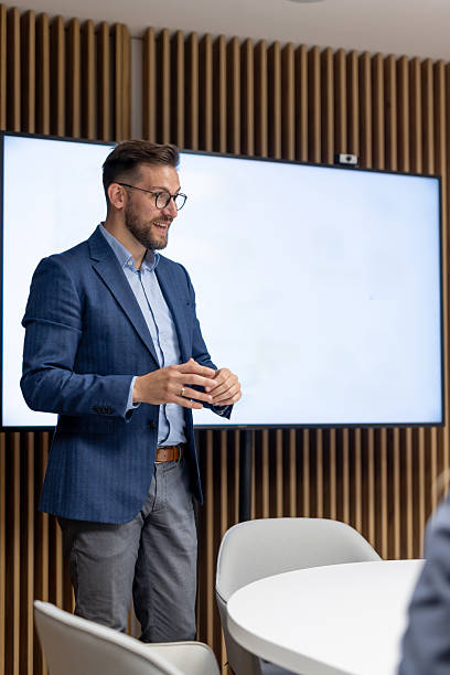istock Businessman leading a presentation in modern office meeting room 2256960882