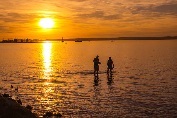 Siofok, Hungary - September 21, 2025: People at sunset in the Lake Balaton.