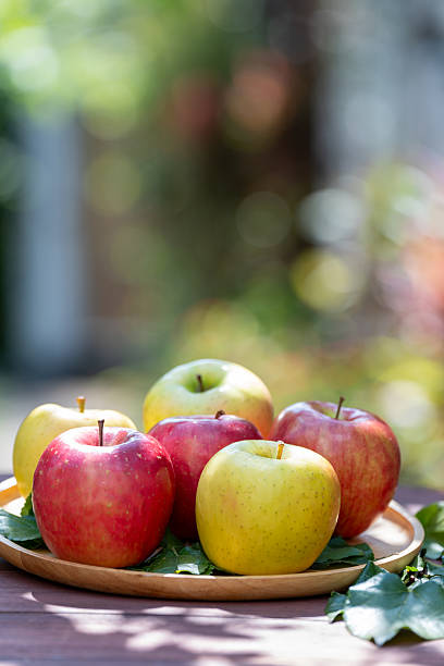 Premium assorted apples arranged in a gift box. Fresh fruit packaging  on white background, ideal for food advertising, healthy lifestyle, and gourmet concept.
