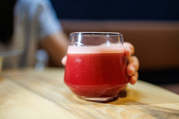 Fresh Beetroot Juice Served in Glass on Wooden Table
