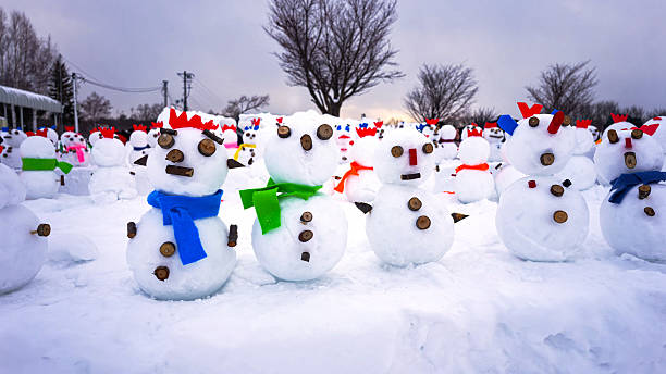 Group of snowmen decorated and adorned by a group of young explorers in winter