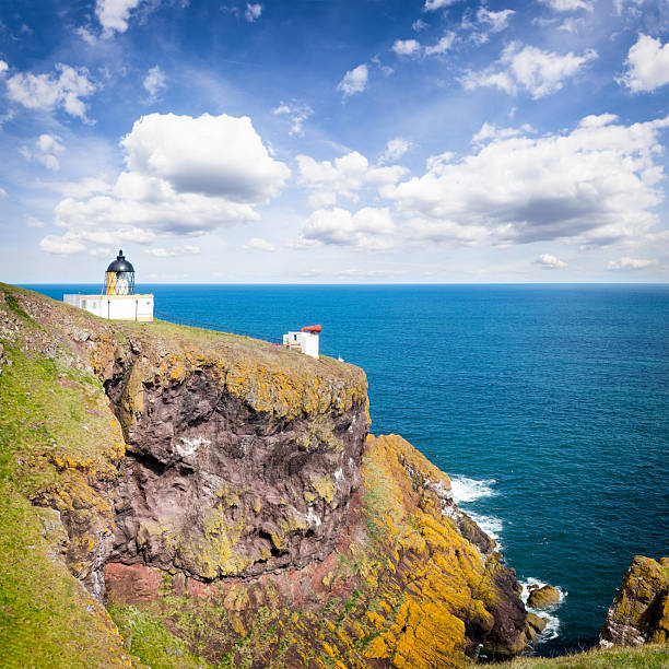 Holidays in Scotland -  Cliff coast with St. Abbs Lighthouse, UK