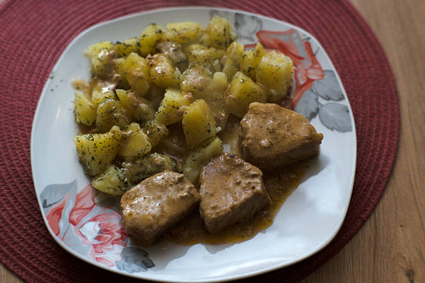 Boiled potatoes with a piece of meat, dinner.