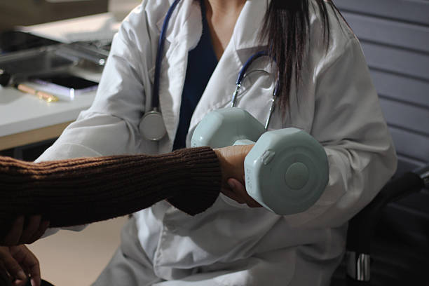 doctor is checking for muscle injuries and using dumbbells test injury and also help with physical therapy strengthen muscles because physical therapy will help strengthen muscles and help blood flow