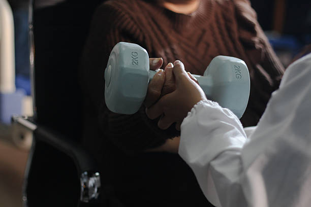 doctor is checking for muscle injuries and using dumbbells test injury and also help with physical therapy strengthen muscles because physical therapy will help strengthen muscles and help blood flow