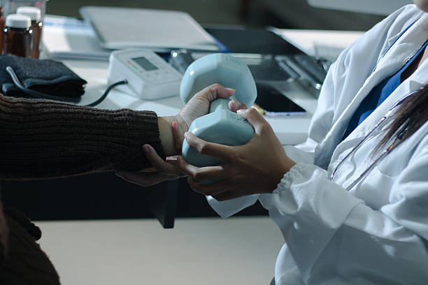 doctor is checking for muscle injuries and using dumbbells test injury and also help with physical therapy strengthen muscles because physical therapy will help strengthen muscles and help blood flow