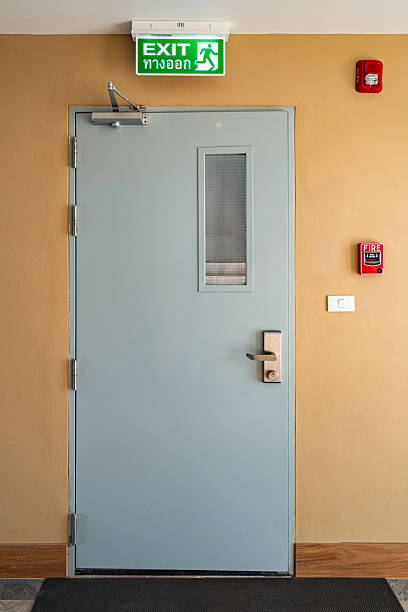 istock Emergency Exit Door with Green Sign, Fire Alarm, and Safety Equipment 2257006589