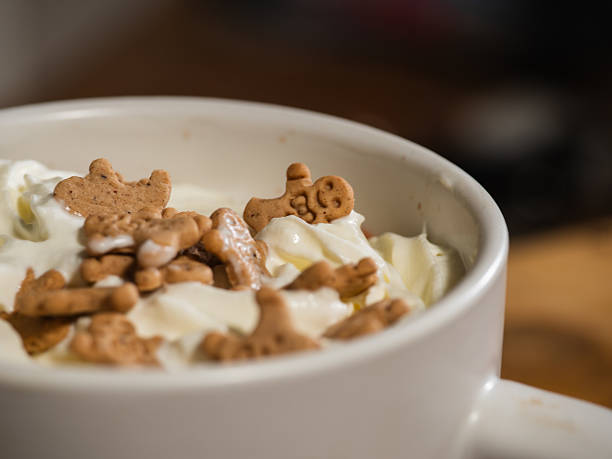 Hot chocolate with whipped cream topping and gingerbread men sprinkles