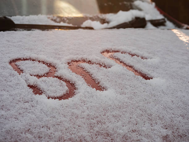 Handwritting message written on a car covered in snow