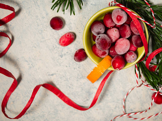 Red ripe cranberries in a bowl for Christmas on white background