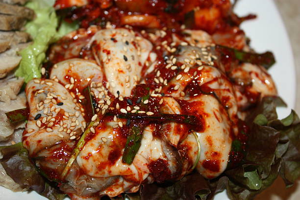 Gul bossam is a Korean dish featuring tender boiled pork served with fresh oysters, napa cabbage, and seasoned radish. The combination of rich pork and briny oysters creates a unique, savory flavor, commonly enjoyed in winter.