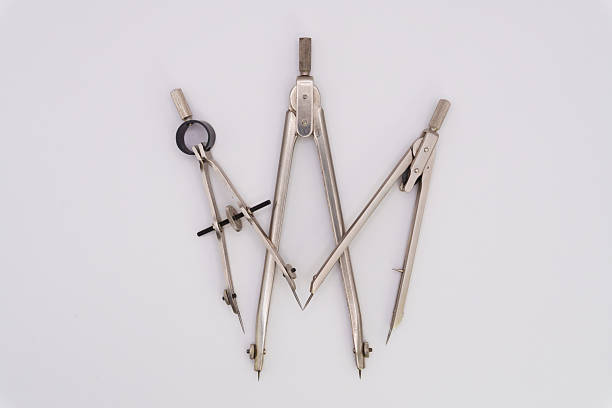 Drawing compass on a white background made of silver-colored metal. High quality