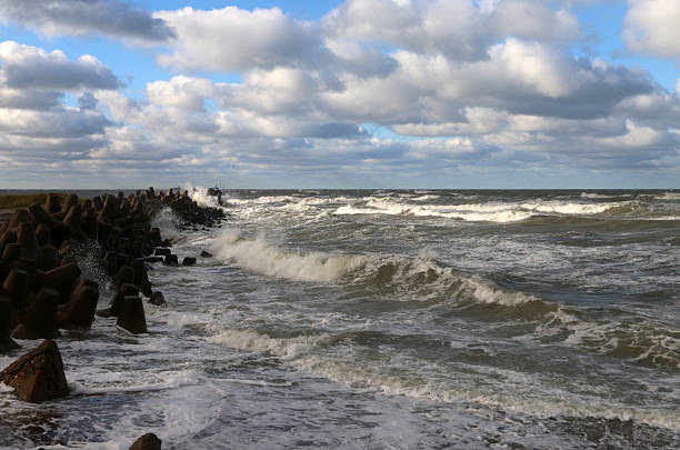 Stormy Baltic Sea with big waves and pier with breakwaters, Europe, Latvia, Liepaja