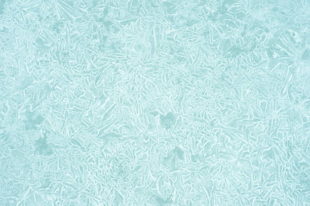 Background with frozen ice crystal texture in light blue with abstract natural pattern white color frost and space for text.