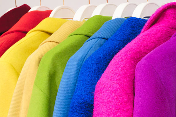 Multicolor family clothes on hangers in store
