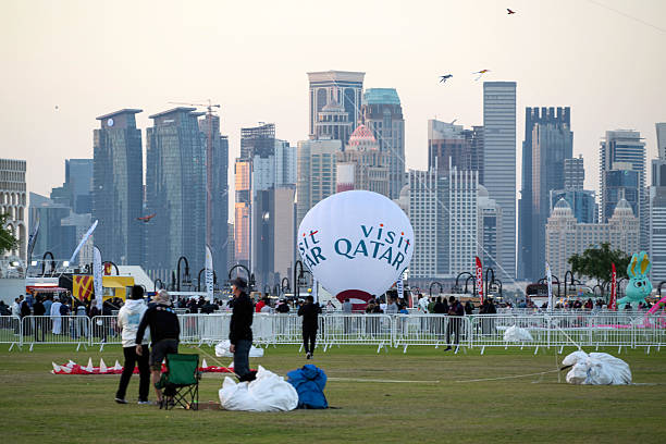 Doha, Qatar - January 18, 2026: Spectators enjoy the large kites flying at Mina district in Qatar as part of Kite Festival 2026. Families and young children in Qatar enjoys the kite festival.
