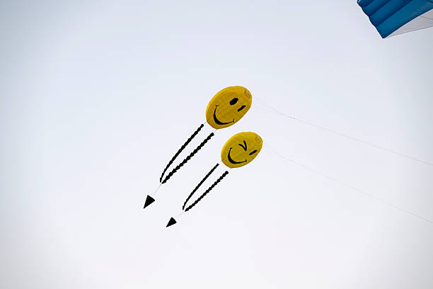 Doha, Qatar - January 18, 2026: Spectators enjoy the large kites flying at Mina district in Qatar as part of Kite Festival 2026. Families and young children in Qatar enjoys the kite festival.