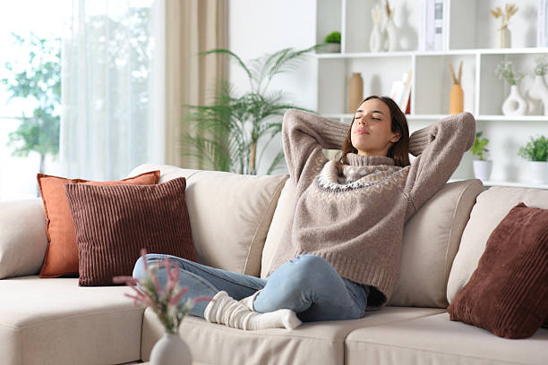 istock Relaxed female in winter resting sitting on a sofa 2257035645