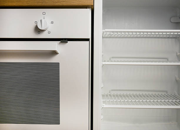 Bright kitchen interior with empty fridge and oven. Food, appliance, hygiene, and lifestyle themes for ads, blogs, and product mockups.