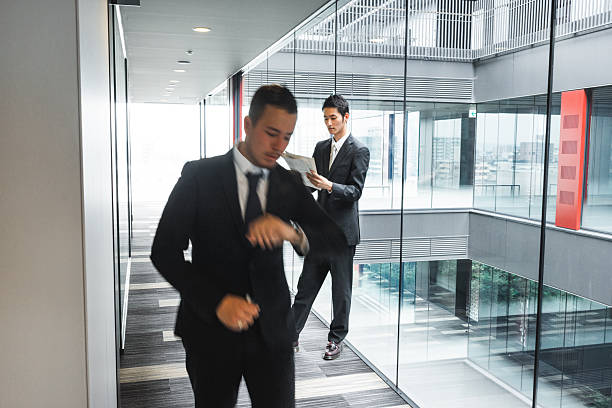 Leader or businessman sends documents female colleague in the creative office.