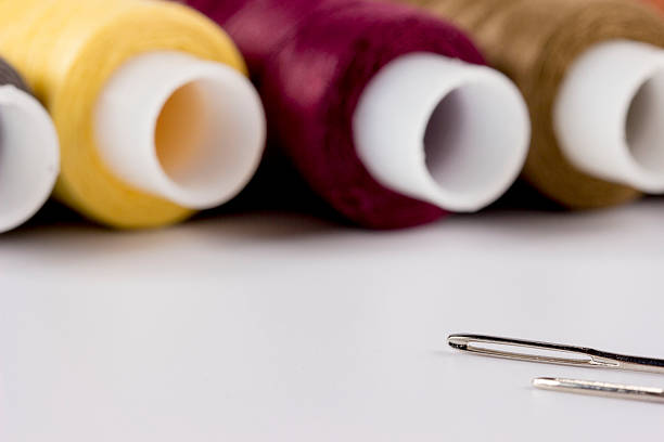 multicolored spools of thread on a white background in close-up