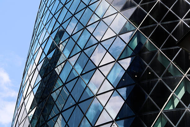 Photograph of The Gherkin (30 St Mary Axe) in London, captured in bright summer daylight. Clear skies and strong natural light highlight the building’s curved glass façade and modern architectural lines. The image showcases the energy and vibrancy of London’s financial district, emphasising one of the city’s most iconic landmarks in crisp, daytime light.