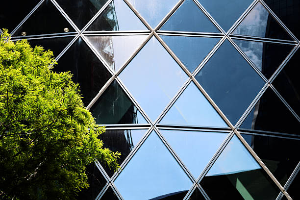 Photograph of The Gherkin (30 St Mary Axe) in London, captured in bright summer daylight. Clear skies and strong natural light highlight the building’s curved glass façade and modern architectural lines. The image showcases the energy and vibrancy of London’s financial district, emphasising one of the city’s most iconic landmarks in crisp, daytime light.
