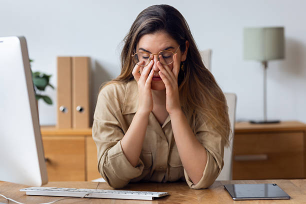 istock Overwhelmed business woman working with computer looking worried at the office 2257053607