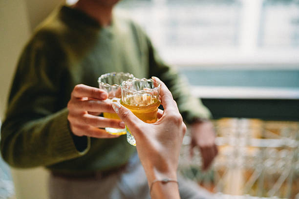 Two people toasting with traditional Moroccan mint tea in decorative glasses, celebrating friendship and lifestyle