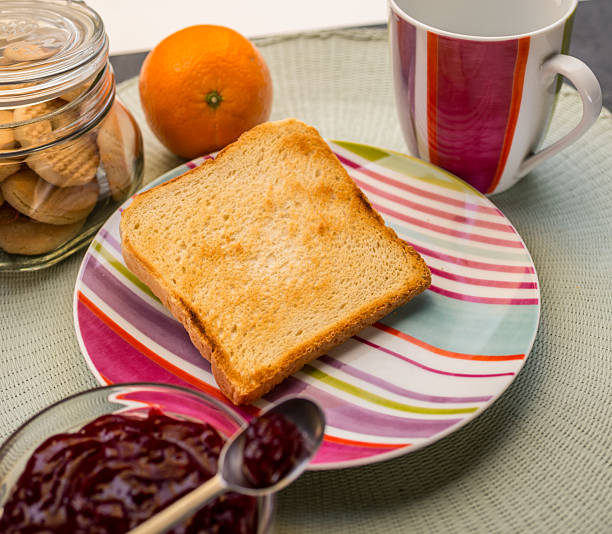 slice of bread , toast , orange, butter