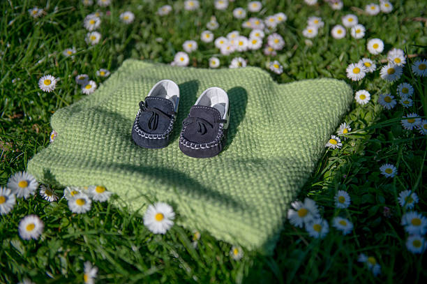 baby shoes in a meadow
