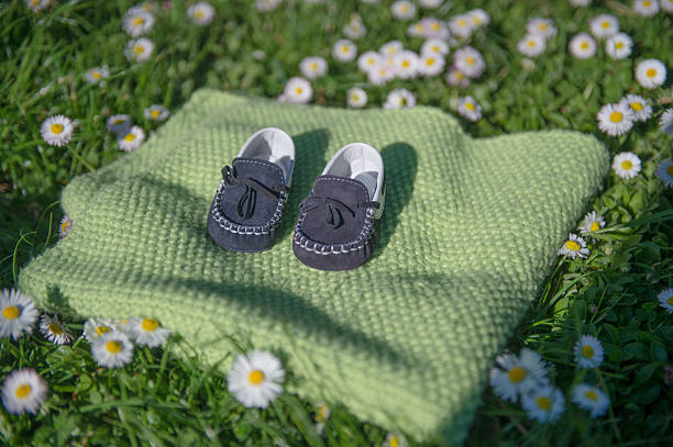 baby shoes in a meadow
