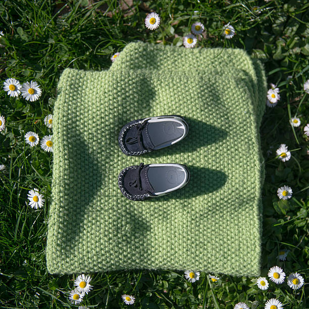 baby shoes in a meadow