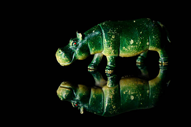 Toy rhinoceros on a black glass background