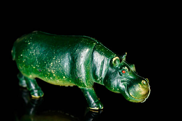 Toy rhinoceros on a black glass background