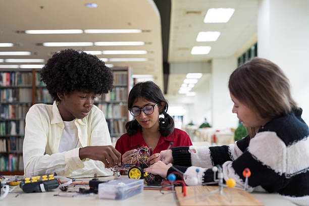 istock Group of students from diverse nationalities learning to assemble robots in library room at school. Robotics academy room. Technology and scientist at school concept 2257061775
