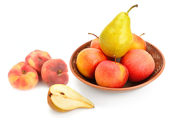 A lot of red apples in a row and a pear standing out. Isolated on white.