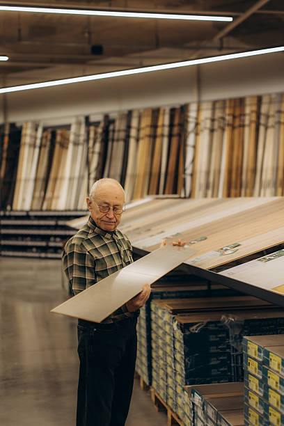 istock Senior man selecting flooring planks for home renovation 2257066418