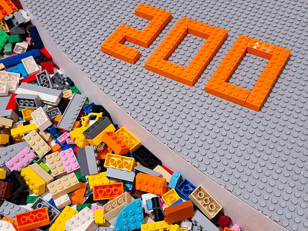Plastic building blocks number two hundred figure on white surface for business milestone achievement and anniversary celebration concept