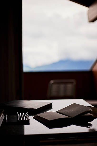 Atmosphere of a Swiss hotel interior featuring travel essentials such as a camera, coffee, tea, a notebook, and a book placed on a table. The scene conveys comfort, inspiration, and a cozy travel lifestyle. Suitable for concepts of tourism, hospitality, leisure, and European accommodation.