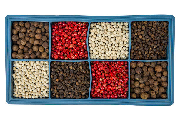 Colorful pepper peppercorns in blue box isolated on white background