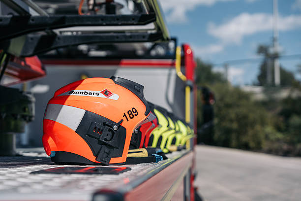 Firefighter adjusting coworker's helmet