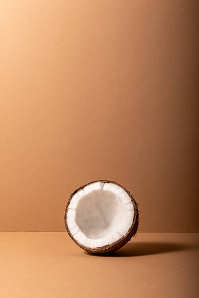 Cracked coconut on bright background. Summer tropical concept.