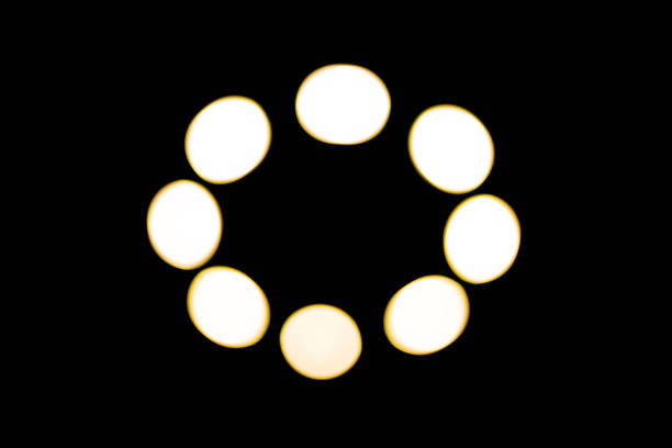 White unfocused bokeh lights on black background.