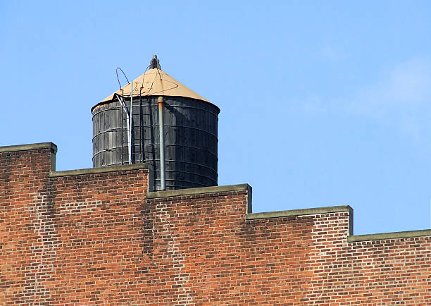 Manhattan classic: the water tower. Every building has at least one, for pressure to eventhe highest floors. Step-down brick wall adds geometric interest. New York City, 2009